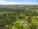 Breathtaking aerial view of the home nestled amongst lush greenery with a private pool and manicured lawn at 255 Seven Island Rd, Pittsboro, NC 27312