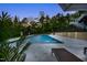 Enjoy the large in-ground pool and travertine patio with comfortable seating in this backyard paradise at 255 Seven Island Rd, Pittsboro, NC 27312
