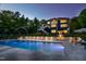 The beautifully lit in-ground pool with fountain features creates a relaxing backyard retreat at 255 Seven Island Rd, Pittsboro, NC 27312