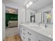 Bathroom with double sinks, white cabinetry, and an open view to the next room at 255 Seven Island Rd, Pittsboro, NC 27312