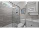 Bathroom featuring a tiled shower with glass door, a white vanity, and a framed mirror at 255 Seven Island Rd, Pittsboro, NC 27312