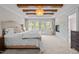 Luxurious main bedroom boasts exposed beams, fireplace, and access to the outdoor balcony at 255 Seven Island Rd, Pittsboro, NC 27312