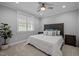 Bedroom with a carved headboard, ceiling fan, neutral carpet, and a window with natural light at 255 Seven Island Rd, Pittsboro, NC 27312