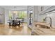 Bright dining room with large windows, a modern chandelier, and an adjacent kitchen with backyard access at 255 Seven Island Rd, Pittsboro, NC 27312