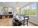 Dining area with a wooden table, bench seating, lots of natural light, and views of the surrounding trees at 255 Seven Island Rd, Pittsboro, NC 27312