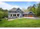 Charming two-story home featuring a covered front porch, a spacious three-car garage and landscaped front yard at 255 Seven Island Rd, Pittsboro, NC 27312