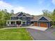 Stately two-story home with a covered porch, multi-car garage, and professionally landscaped yard at 255 Seven Island Rd, Pittsboro, NC 27312