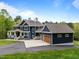 A lovely exterior view of a two-story home with an attached three-car garage and front lawn at 255 Seven Island Rd, Pittsboro, NC 27312