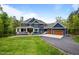 Beautiful two-story home with a covered front porch and a three-car garage on a lush, green lawn at 255 Seven Island Rd, Pittsboro, NC 27312