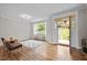 Inviting foyer with hardwood floors, a large window, and an open doorway leading to the outdoors at 255 Seven Island Rd, Pittsboro, NC 27312