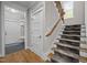 Bright foyer featuring hardwood floors, carpeted stairs and entry to additional rooms at 255 Seven Island Rd, Pittsboro, NC 27312