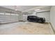 Spacious garage with multiple doors and ample room for vehicle storage, complete with epoxy flooring at 255 Seven Island Rd, Pittsboro, NC 27312