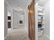 Hallway features a sliding barn door, built-in shelving and access to laundry room and bedroom at 255 Seven Island Rd, Pittsboro, NC 27312