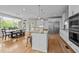 Bright, open kitchen with a large island, stainless steel appliances, and a dining area with scenic views at 255 Seven Island Rd, Pittsboro, NC 27312