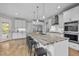 Modern kitchen featuring a large island with barstool seating, stainless steel appliances, and custom cabinetry at 255 Seven Island Rd, Pittsboro, NC 27312