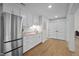 Convenient kitchenette with stainless steel refrigerator and white cabinets at 255 Seven Island Rd, Pittsboro, NC 27312