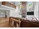 Bright living room features a stone fireplace, hardwood floors, and a balcony overlooking the open space at 255 Seven Island Rd, Pittsboro, NC 27312
