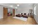 Inviting living room boasts a comfortable brown leather sofa, plush rug, and barn door access to playroom at 255 Seven Island Rd, Pittsboro, NC 27312
