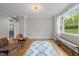 Bright and airy living room features hardwood floors, a large window with natural light, and neutral tones at 255 Seven Island Rd, Pittsboro, NC 27312