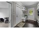 Mudroom with bench seating, storage shelves, tile floors, and access to the home's interior and exterior at 255 Seven Island Rd, Pittsboro, NC 27312