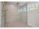 Contemporary walk-in shower with glass partition and window for natural light at 255 Seven Island Rd, Pittsboro, NC 27312