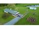 An aerial view of a charming country home, featuring a garden, pond, and a long gravel driveway at 2960 Epps Clark Rd, Siler City, NC 27344