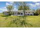 Expansive backyard with a lovely home, patio, and mature trees at 2960 Epps Clark Rd, Siler City, NC 27344