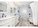 Elegant bathroom featuring a double vanity, freestanding tub, patterned tile floor, and vintage-inspired fixtures at 2960 Epps Clark Rd, Siler City, NC 27344
