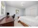This is a bedroom featuring a wooden desk area, a queen bed, and lots of natural light coming in from the windows at 2960 Epps Clark Rd, Siler City, NC 27344