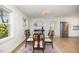 Bright dining room featuring a glass table, hardwood floors, and white shiplap walls, creating a modern, inviting space at 2960 Epps Clark Rd, Siler City, NC 27344