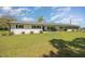 Attractive single-story home with a brick facade, a green metal roof, and well-maintained landscaping at 2960 Epps Clark Rd, Siler City, NC 27344
