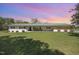 Charming single-story home with a brick facade, spacious front yard and rocking chairs on a covered porch at 2960 Epps Clark Rd, Siler City, NC 27344
