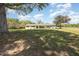 Charming single-story brick home with a lush green lawn and metal roof against a bright blue sky at 2960 Epps Clark Rd, Siler City, NC 27344