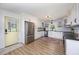 Modern kitchen featuring stainless steel appliances, shaker cabinets, black counters and a view of the outdoors at 2960 Epps Clark Rd, Siler City, NC 27344
