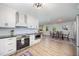 Bright kitchen with white cabinets, stainless steel appliances, and an open concept to the dining area at 2960 Epps Clark Rd, Siler City, NC 27344