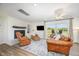 Spacious living room features wood-look floors, a fireplace, and patio access to a backyard view at 2960 Epps Clark Rd, Siler City, NC 27344