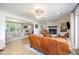 Comfortable living room with a fireplace, leather seating, wood-look floors, and access to other rooms at 2960 Epps Clark Rd, Siler City, NC 27344