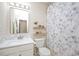 Clean bathroom with a stylish mirror, vanity, toilet, and shower with patterned curtain at 308 Apricot Cir, Morrisville, NC 27560