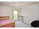 Bright bedroom featuring a ceiling fan, large window, and built in storage at 308 Apricot Cir, Morrisville, NC 27560