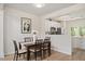 Dining area with wood floors adjacent to the kitchen with white cabinets at 308 Apricot Cir, Morrisville, NC 27560
