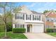 Charming two-story home with well-maintained landscaping, gray door and black shutters, plus an attached one-car garage at 308 Apricot Cir, Morrisville, NC 27560