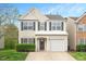 Charming two-story home with well-maintained landscaping, gray door and black shutters, plus an attached one-car garage at 308 Apricot Cir, Morrisville, NC 27560