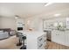 Bright kitchen featuring white cabinets, stainless steel appliances and a spacious island with bar stool seating at 308 Apricot Cir, Morrisville, NC 27560