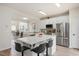Modern kitchen featuring stainless steel appliances, white cabinets, stylish backsplash, and an island with bar seating at 308 Apricot Cir, Morrisville, NC 27560