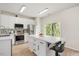 Modern kitchen featuring stainless steel appliances, white cabinets, stylish backsplash, and an island with bar seating at 308 Apricot Cir, Morrisville, NC 27560