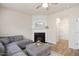 Cozy living room featuring a fireplace, large sectional sofa, neutral tones and open floor plan at 308 Apricot Cir, Morrisville, NC 27560