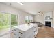 Open concept living area with fireplace, large windows, sliding glass door, and view into the kitchen at 308 Apricot Cir, Morrisville, NC 27560