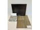 Interior materials showcase including dark wood cabinets, speckled granite, and luxury vinyl plank flooring sample at 344 Chesapeak Commons St # 138, Garner, NC 27529