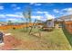 Spacious backyard with a wooden fence, playground, and a lush green lawn, perfect for outdoor activities at 350 Stephens Way, Youngsville, NC 27596