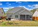 Landscaped backyard with a screened-in porch, a green lawn, grill, and a hammock, great for entertaining at 350 Stephens Way, Youngsville, NC 27596